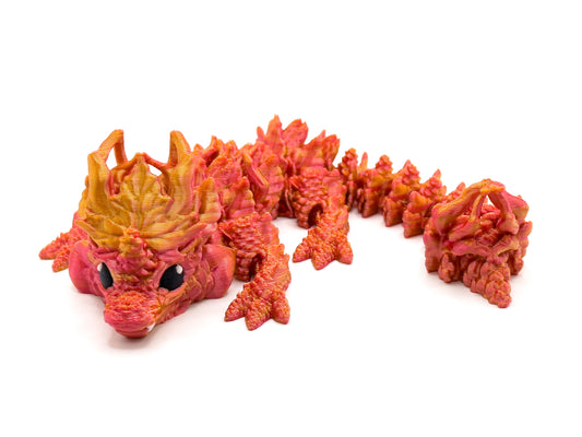 Baby Autumn Dragon positioned so that the face and the back of its tail are visible.