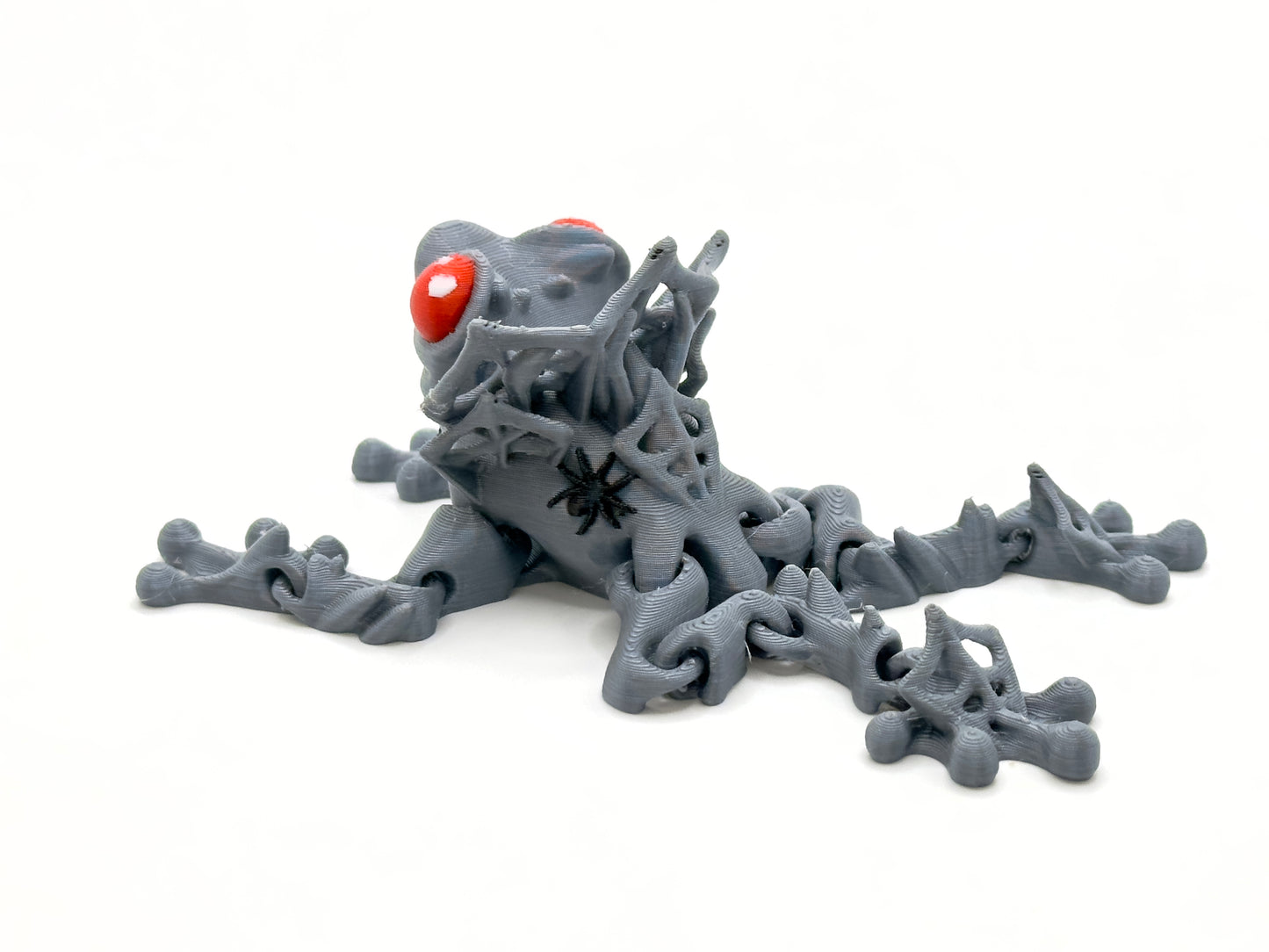 Count Frogula grey with red eyes rear. Count Frogula is a frog with the teeth and "collar" of a vampire