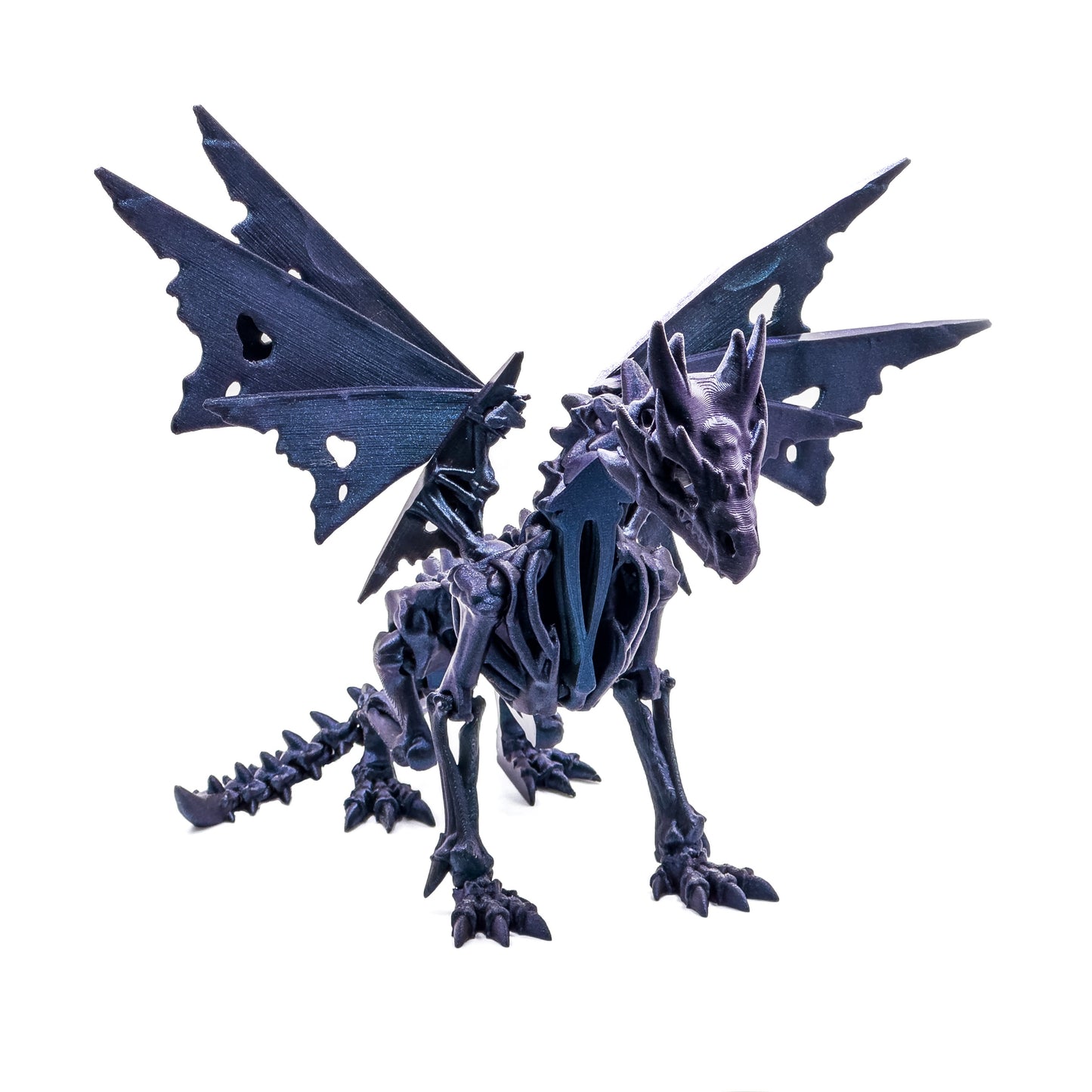 Front view of a dark blue, skeleton looking dragon. Its wings are fanned.